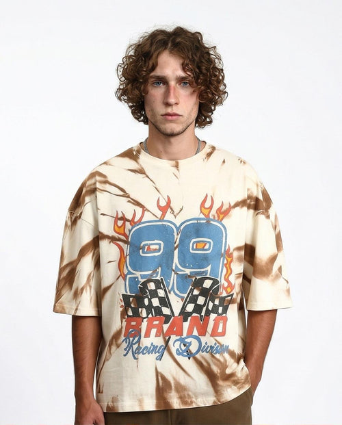 Man wearing a tie-dye t-shirt with '80 Brand Racing Division' design on a plain background