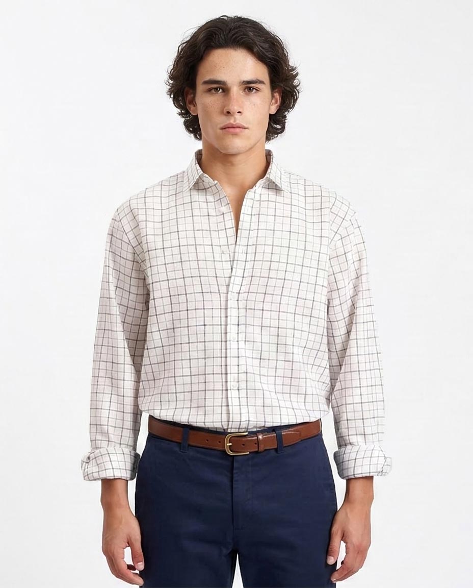 Man wearing a checkered shirt and navy pants on a white background