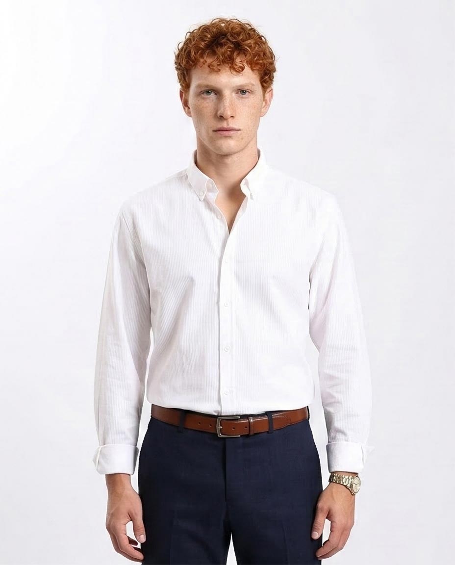 Man wearing a white dress shirt and navy pants on a white background
