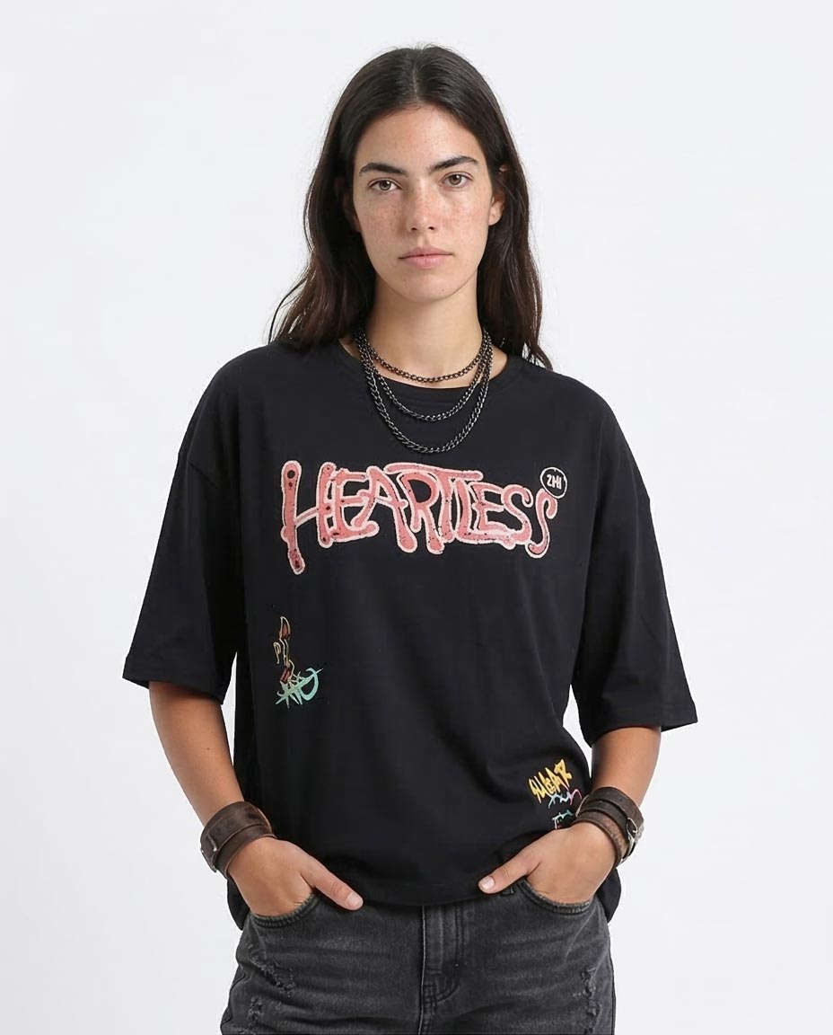 Person wearing a black t-shirt with colorful graphics and text on a white background