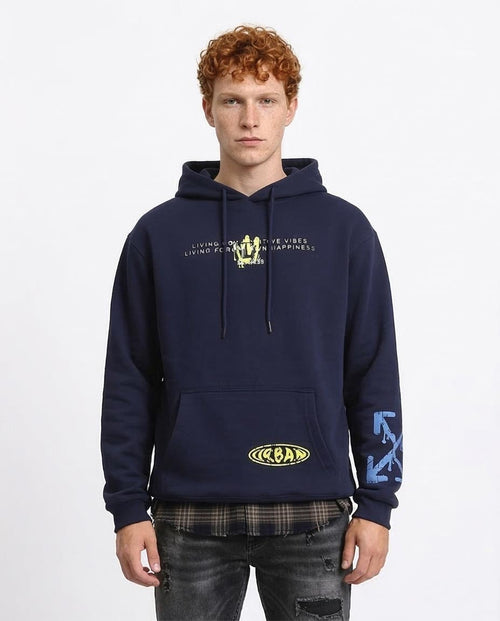 Man wearing a navy blue hoodie with text and logos on a white background
