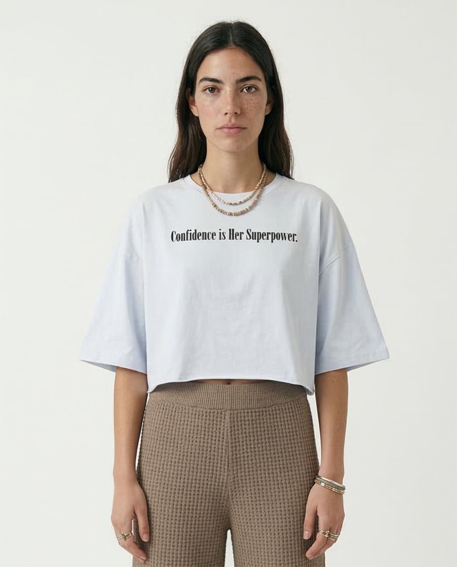 Woman wearing a white t-shirt with text on a plain background