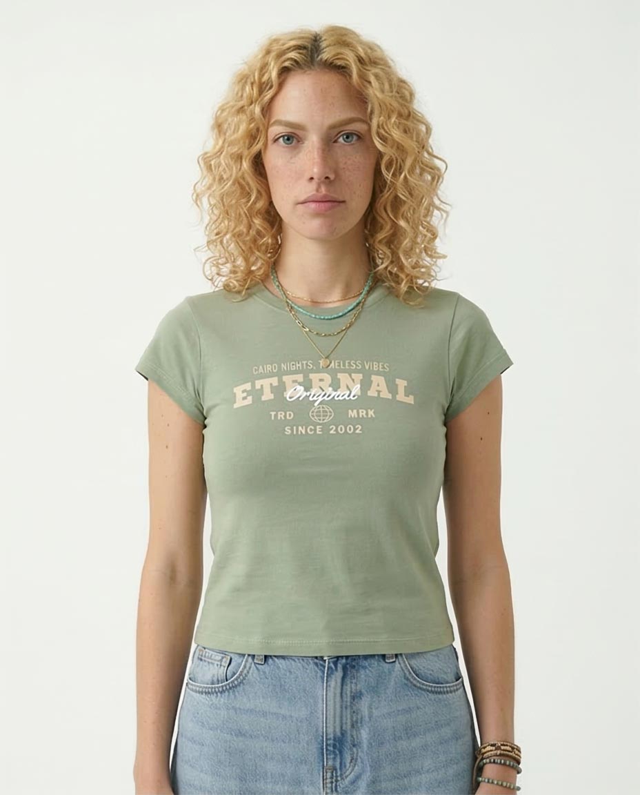 Woman wearing a green t-shirt with text and blue jeans on a white background
