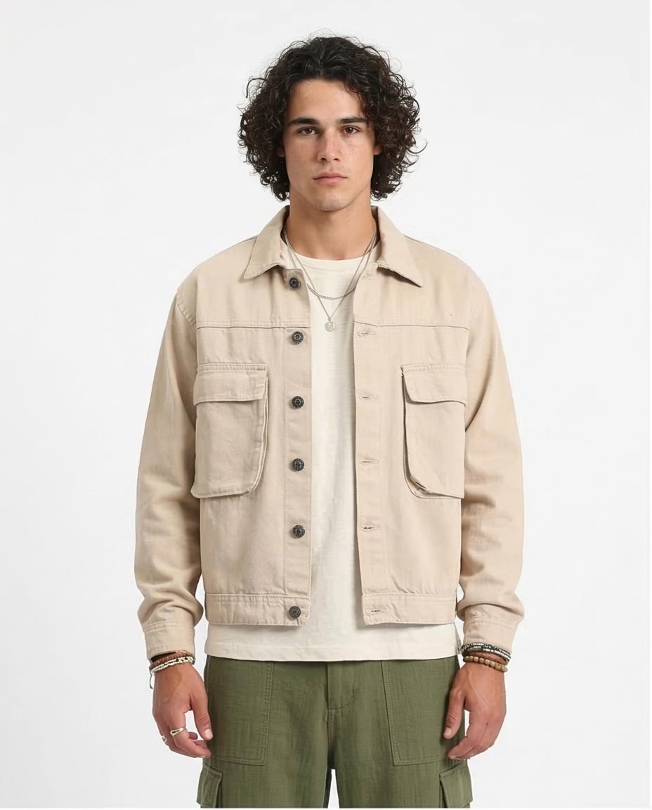 Man wearing a beige jacket with a plain background