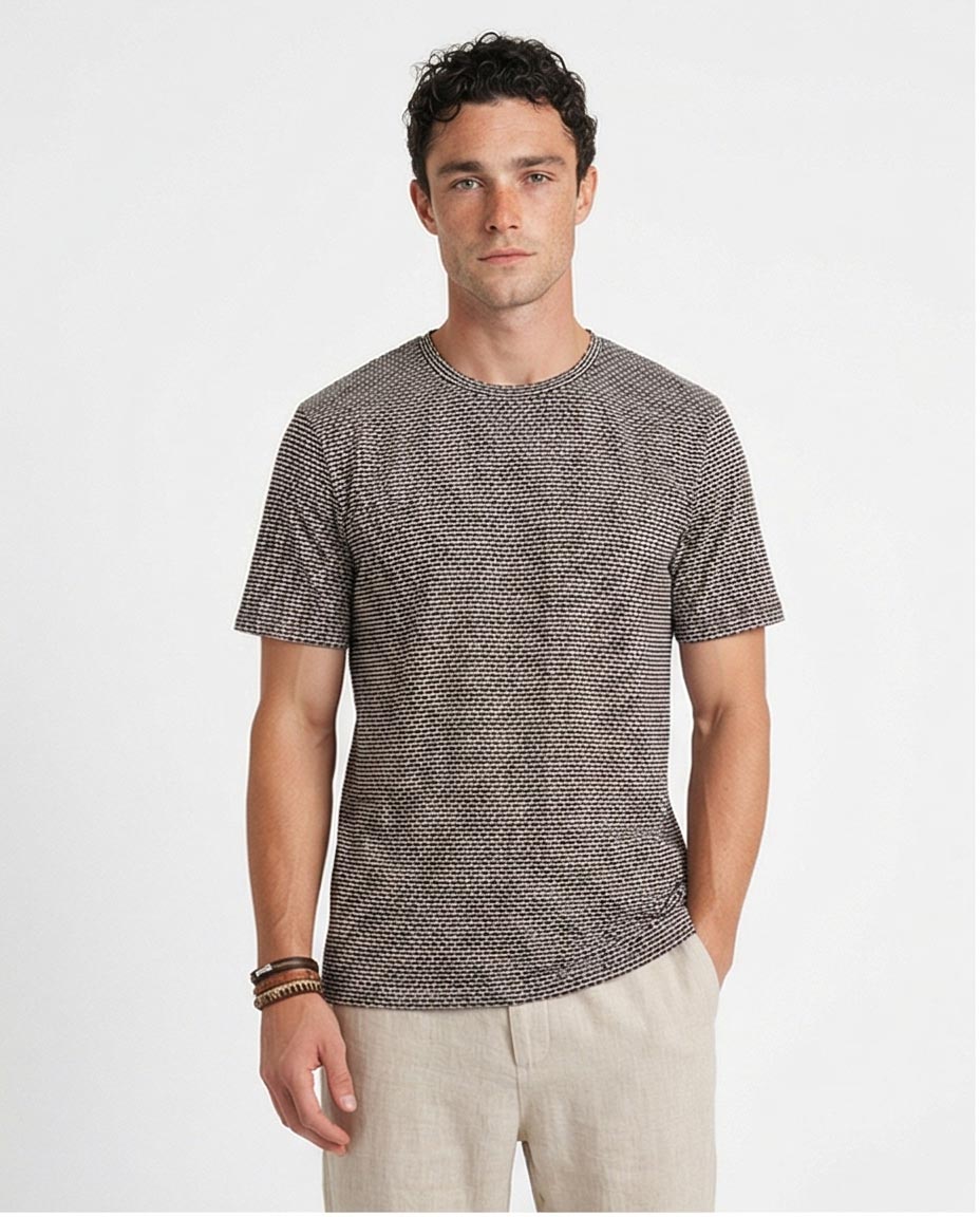 Man wearing a patterned gray t-shirt on a white background