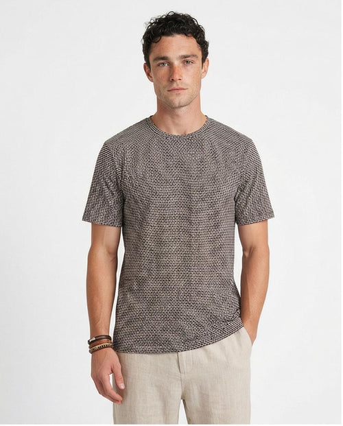 Man wearing a patterned gray t-shirt on a white background