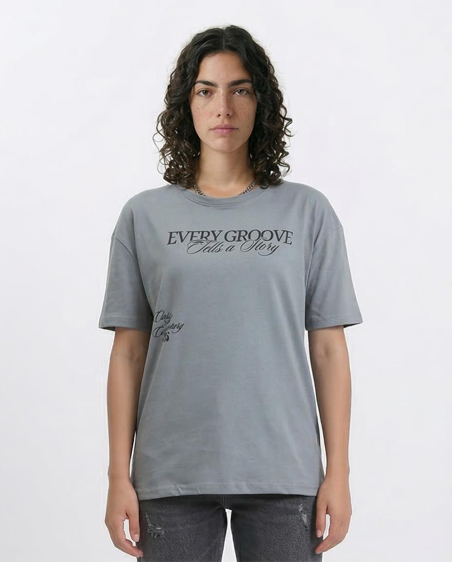 Woman wearing a gray t-shirt with text on a white background