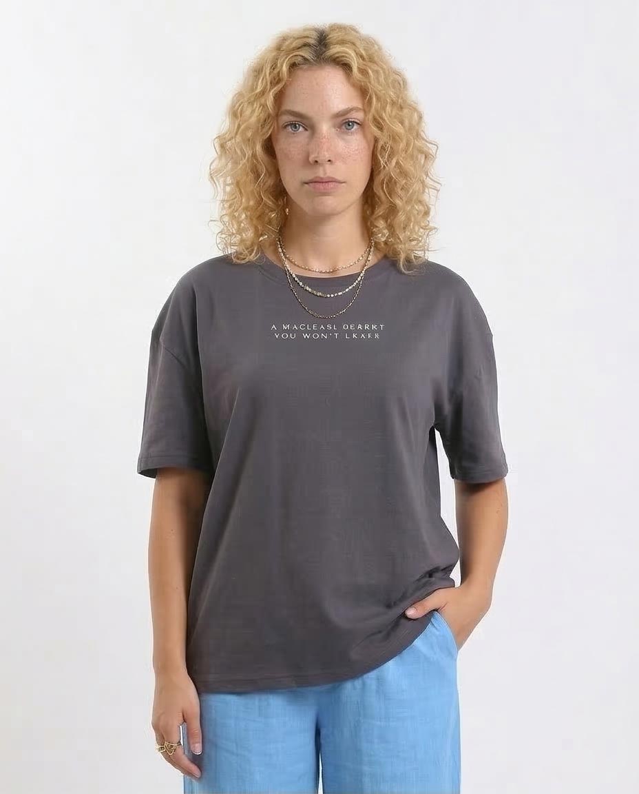 Woman wearing a gray t-shirt with text on a white background