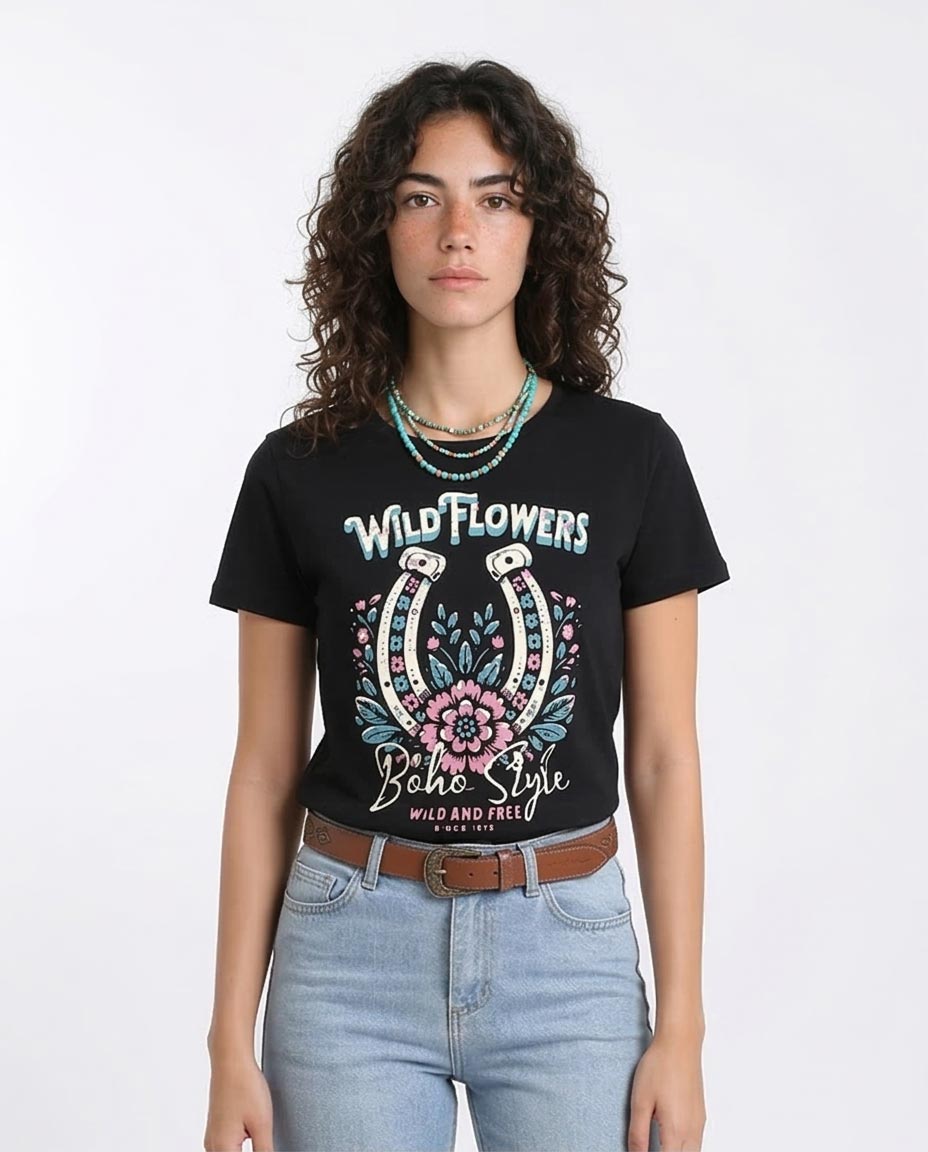 Woman wearing a black t-shirt with floral horseshoe design and text on a white background