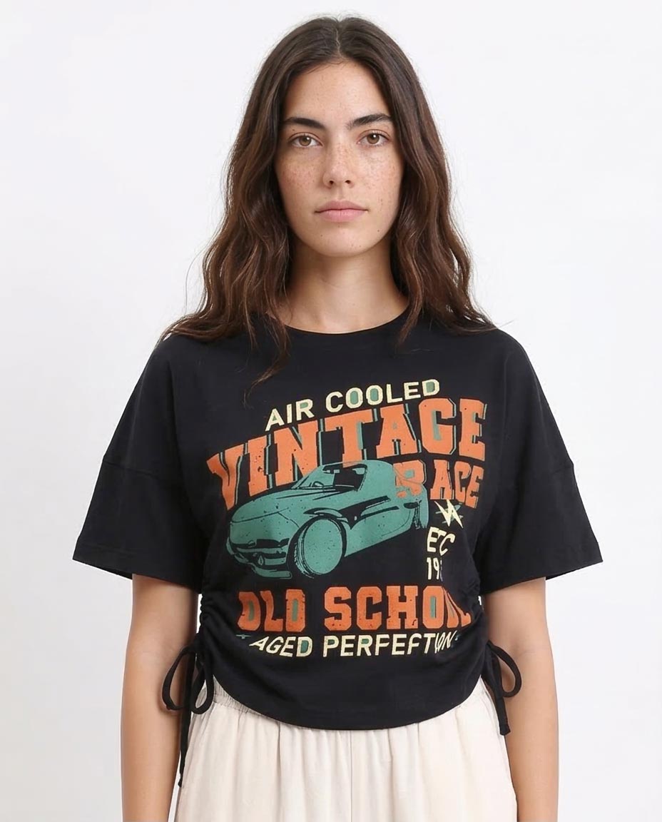 Woman wearing a black t-shirt with vintage race car graphic and text.