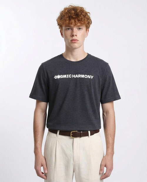 Person wearing a black t-shirt with 'OMIC HARMONY' text on a white background