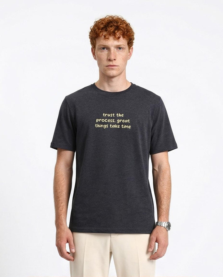 Man wearing a black t-shirt with text on a white background