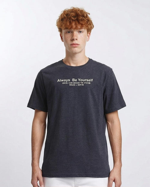 Person wearing a dark blue t-shirt with text on a white background