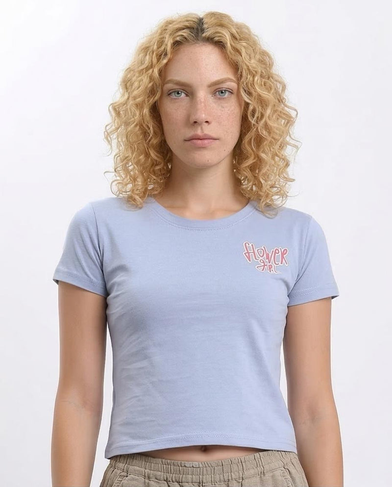 Woman wearing a light blue t-shirt with a logo on a white background