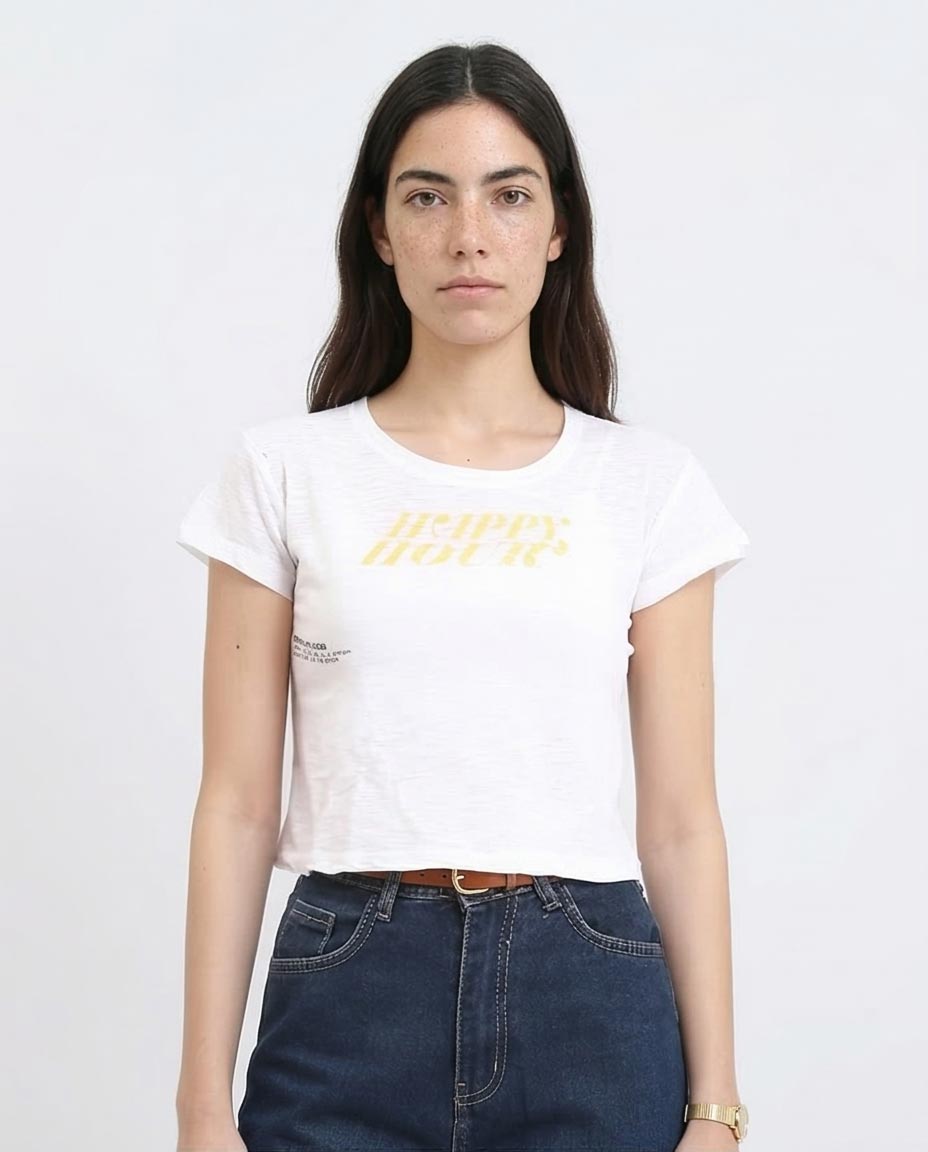 Woman wearing a white t-shirt with yellow text and blue jeans on a plain background