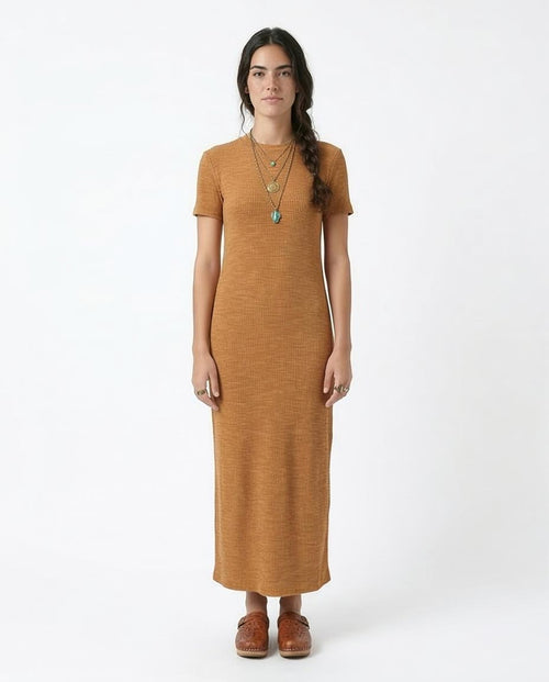 Woman wearing a mustard yellow dress on a white background