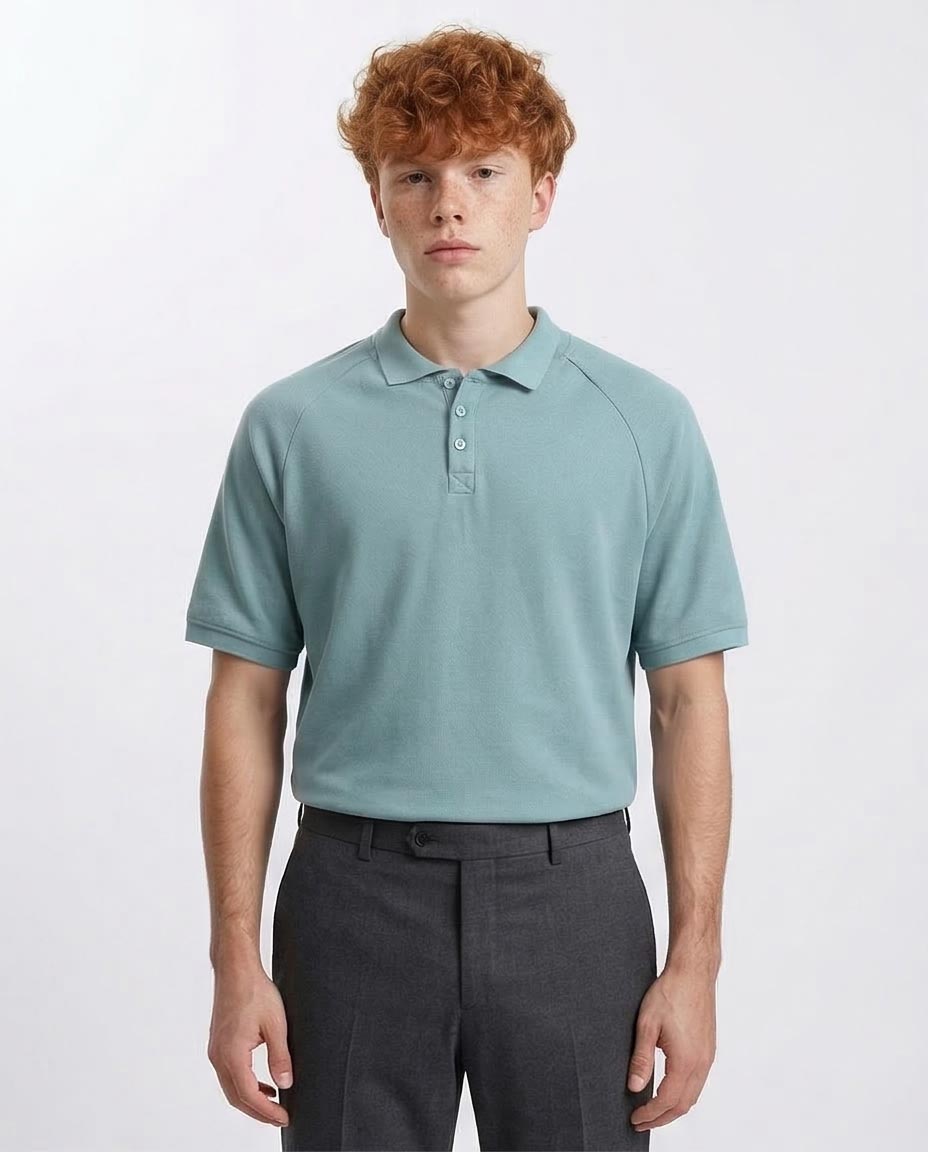 Man wearing a light blue polo shirt and dark gray pants on a white background