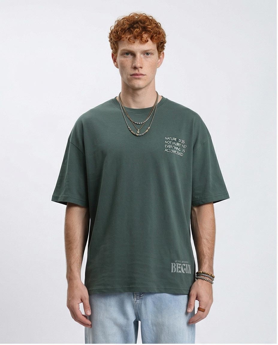 Man wearing a green t-shirt with text on a white background