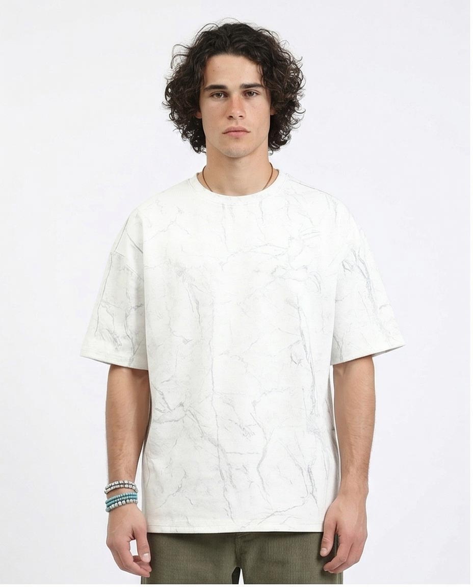 Man wearing a white textured t-shirt on a plain background