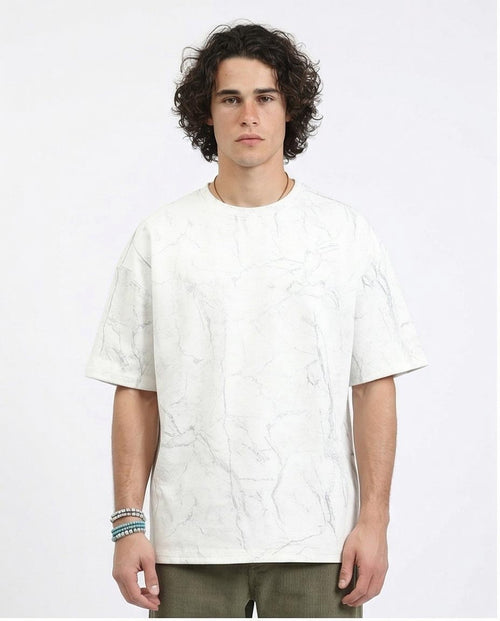 Man wearing a white textured t-shirt on a plain background