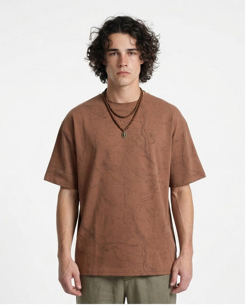 Man wearing a brown t-shirt against a white background