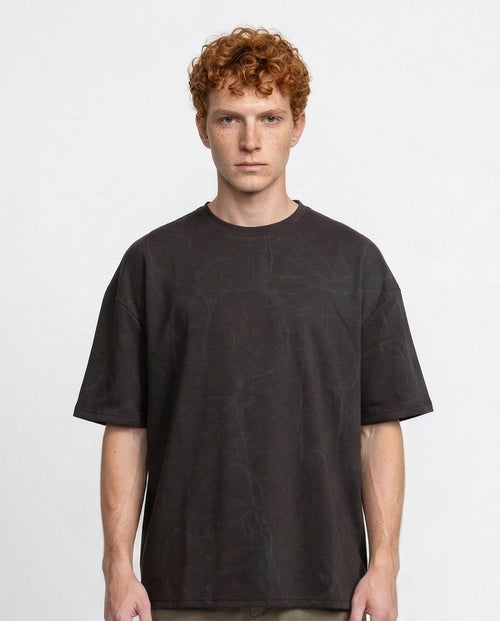 Man wearing a black t-shirt against a plain background