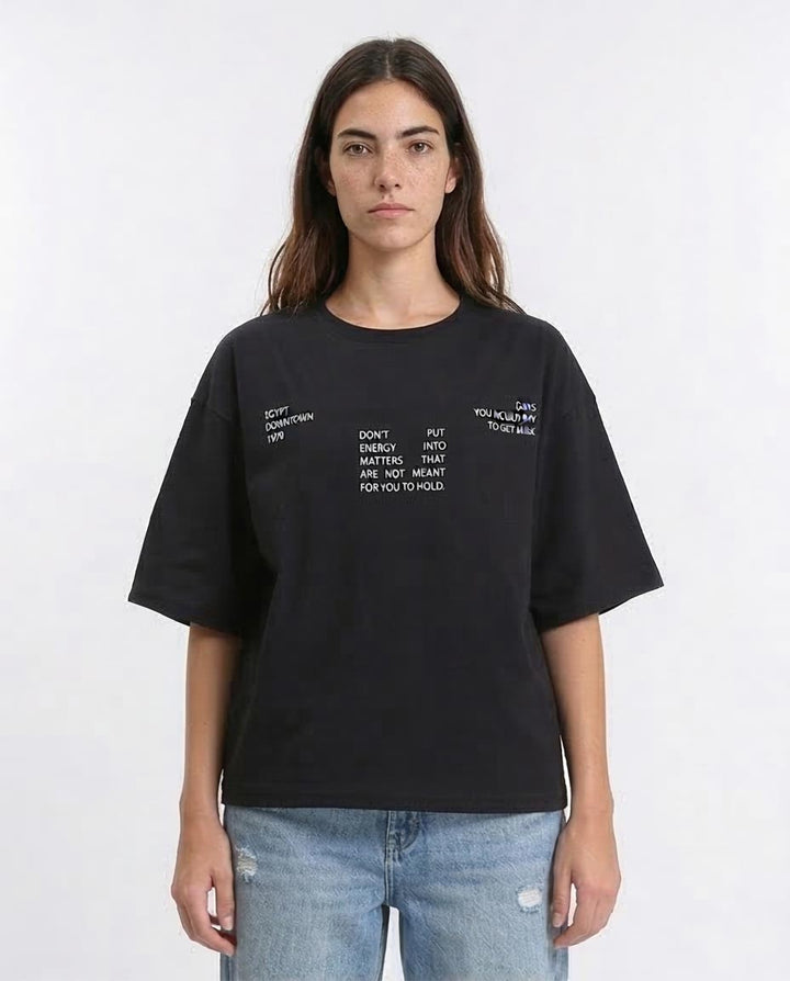Woman wearing a black t-shirt with text on a white background