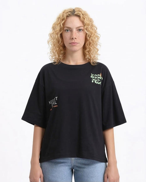 Woman wearing a black t-shirt with text on a white background