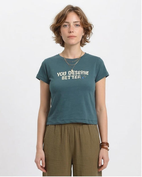 Woman wearing a teal t-shirt with 'YOU DESERVE BETTER' text on a white background