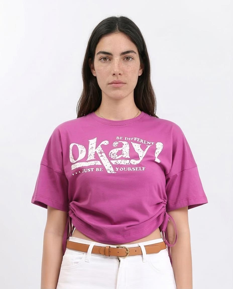 Woman wearing a pink t-shirt with a motivational quote on a white background