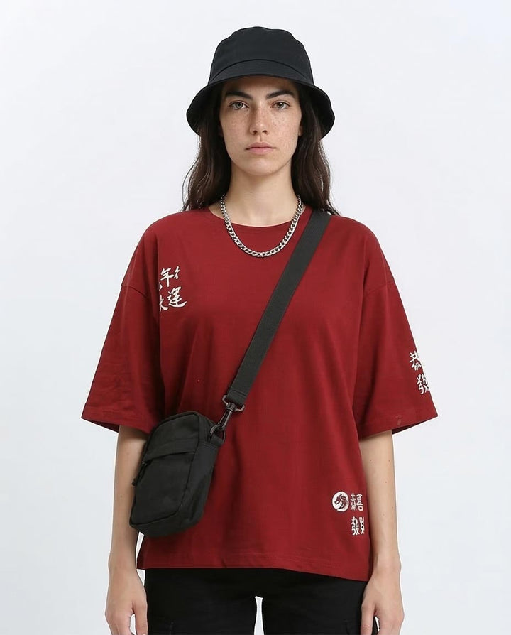 Woman wearing a red t-shirt with text, black bucket hat, and black crossbody bag on a white background