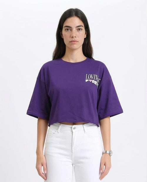 Woman wearing a purple t-shirt with text on a white background