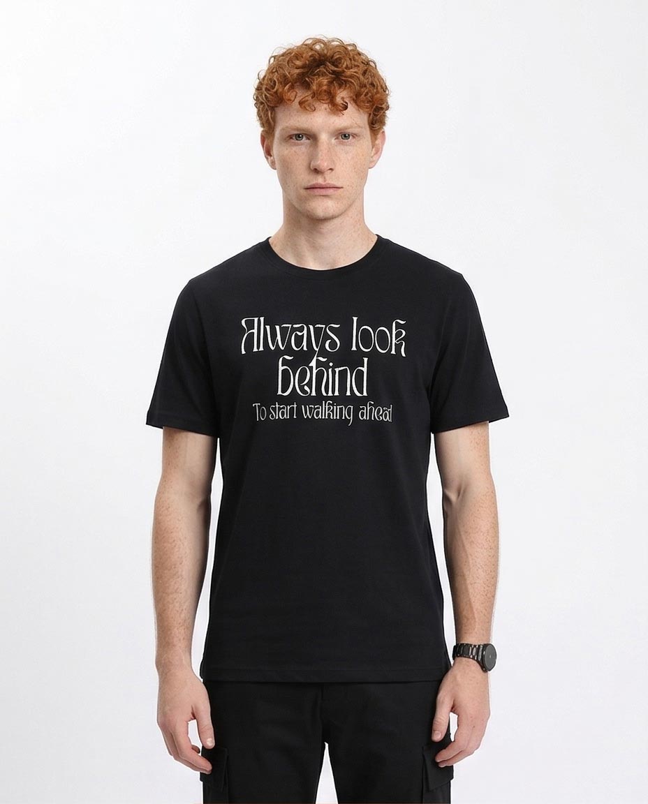 Man wearing a black t-shirt with text on a white background