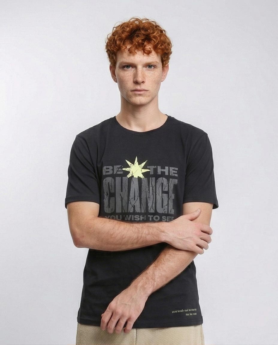 Man wearing a black t-shirt with 'Be the Change' text on a white background