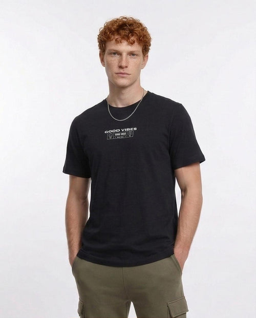 Man wearing a black t-shirt with text on a white background