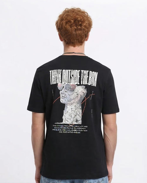 Person wearing a black t-shirt with a graphic design and text on the back, on a white background