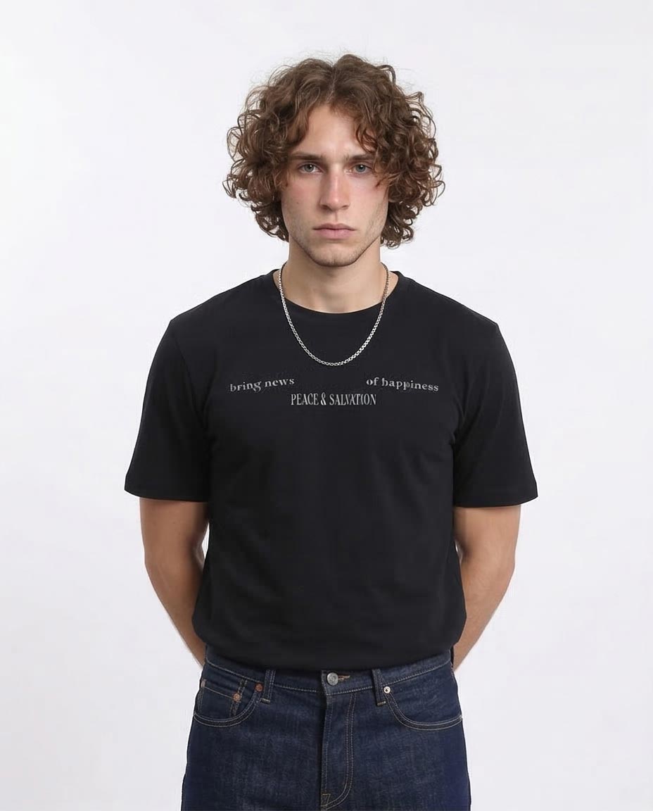 Person wearing a black t-shirt with text on a white background