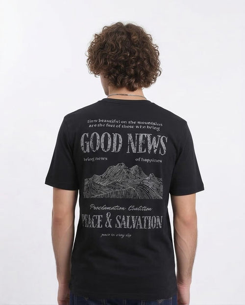 Person wearing a black t-shirt with text and mountain graphic on the back, on a white background