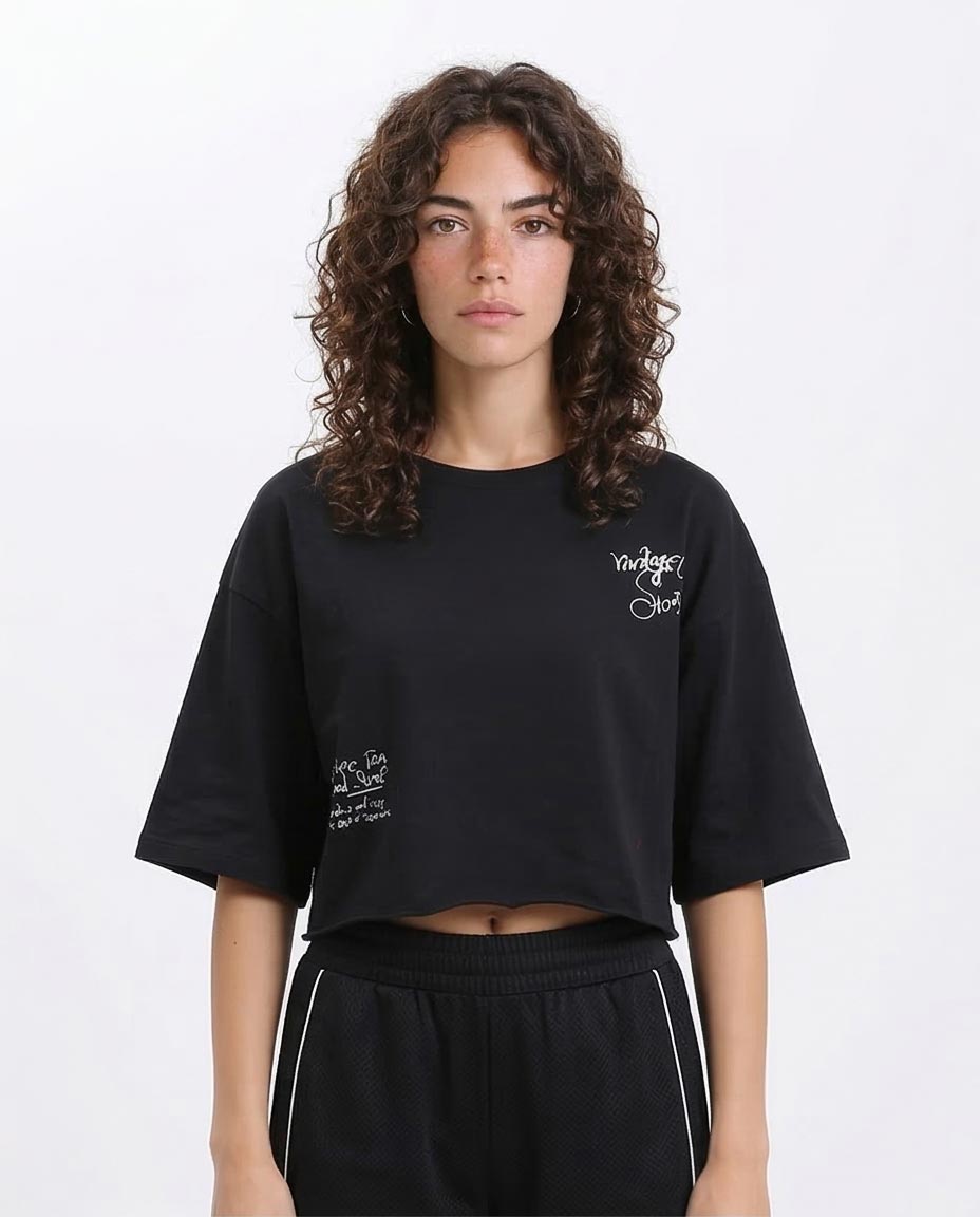 Woman wearing a black oversized t-shirt with text on a white background