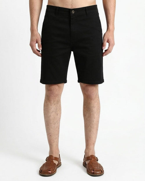 Man wearing black shorts on a white background