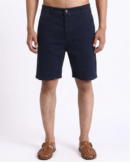 Person wearing navy shorts on a white background