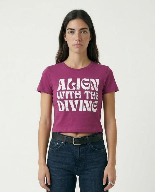 Woman wearing a purple t-shirt with 'Align with the Divine' text on a plain background
