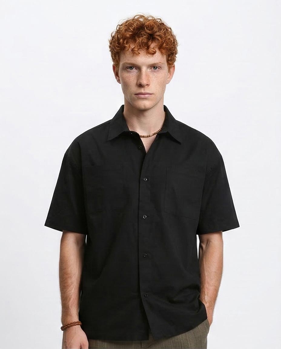 Man wearing a black short-sleeve shirt on a white background