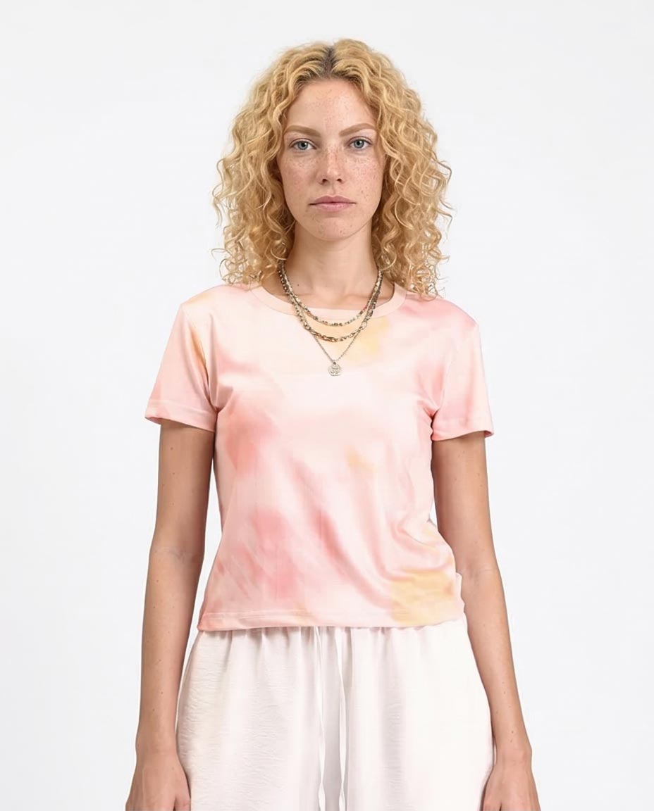 Woman wearing a tie-dye t-shirt with a plain background