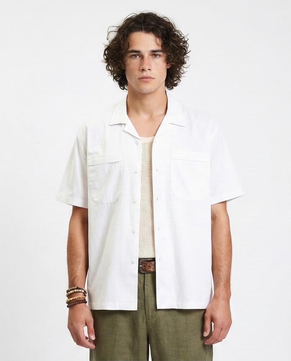 Man wearing a white shirt with a patterned tie and green pants on a white background