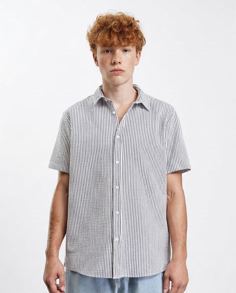 Person wearing a short-sleeve checkered shirt on a white background