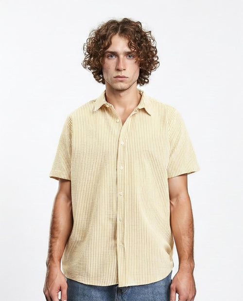 Man wearing a yellow striped shirt against a white background