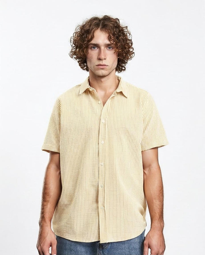 Man wearing a yellow striped shirt against a white background
