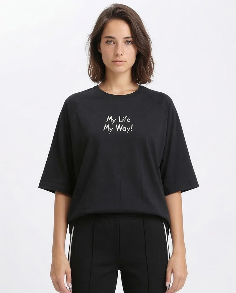 Person wearing a black t-shirt with 'My Life My Way' text on a white background