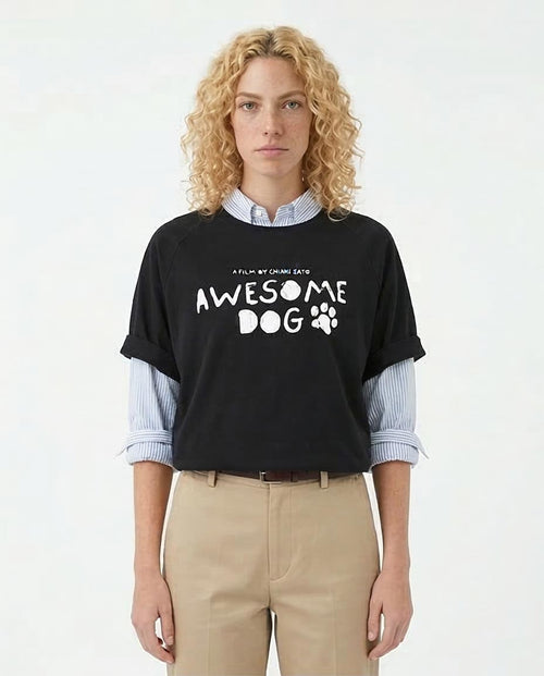 Person wearing a black t-shirt with 'Awesome Dog' text and paw print design on a white background